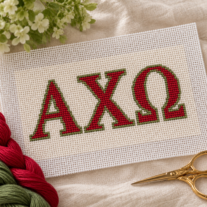 Alpha Chi Omega needlepoint canvas with ΑΧΩ letters and gold lyre motif over scarlet red and olive green stripes