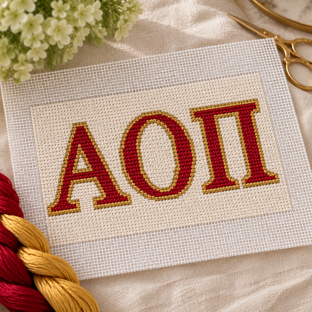 Alpha Omicron Pi needlepoint canvas with ΑΟΠ letters and cardinal red rose motif over cardinal red and white stripes