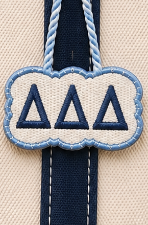 Tri Delta needlepoint canvas with ΔΔΔ letters and gold trident motif over cerulean blue and white stripes