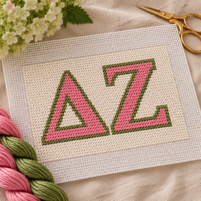 Delta Zeta needlepoint canvas featuring ΔΖ letters over rose pink and vintage green stripes