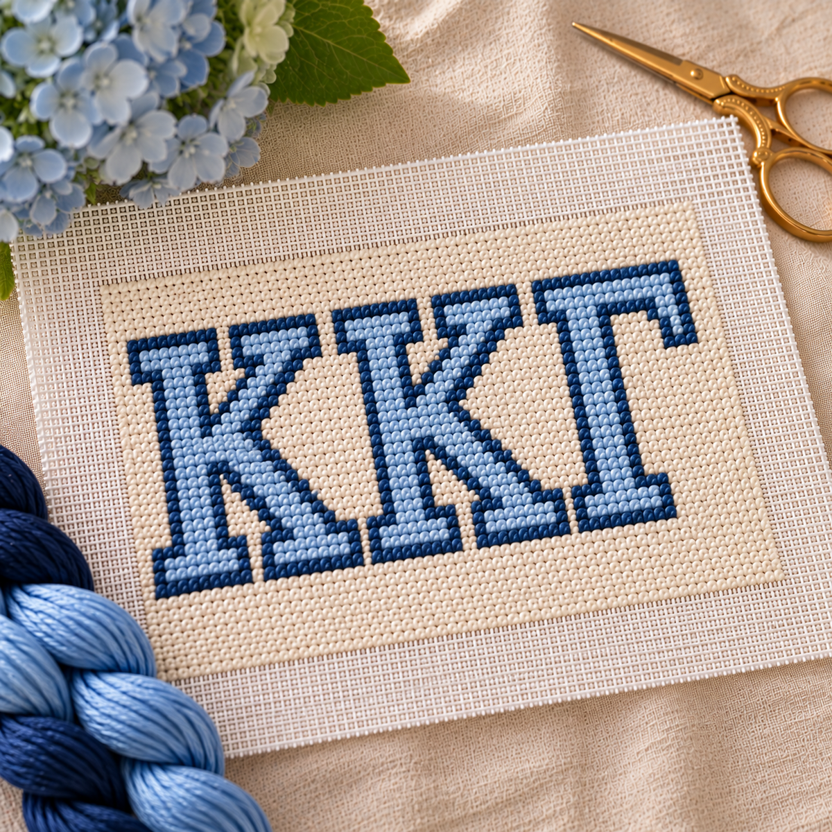Kappa Kappa Gamma needlepoint canvas with ΚΚΓ letters and gold key motif over light blue and white stripes